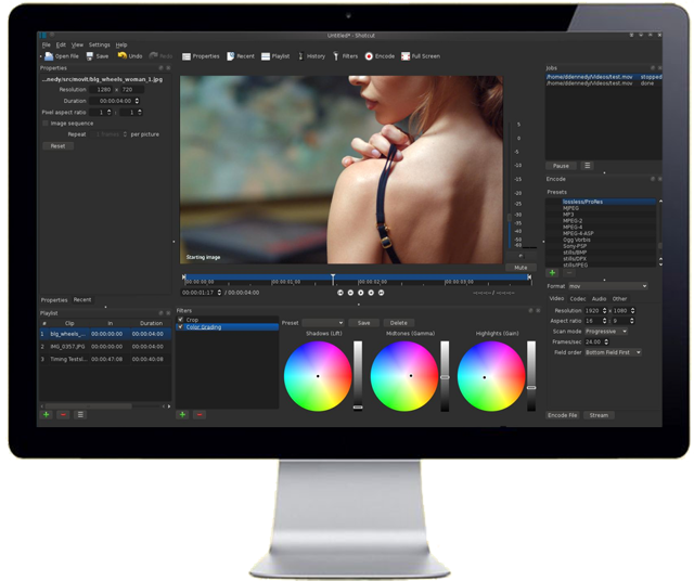 Official Shotcut historical UI showing the editor, preview, filters and scopes on a desktop monitor.